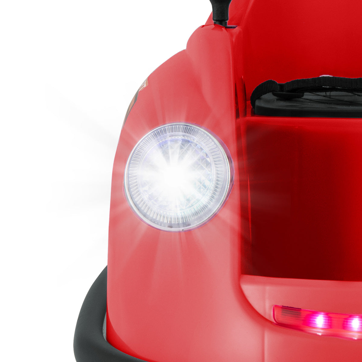 Close-up of the bright LED headlight on the front of the red electric bumper car