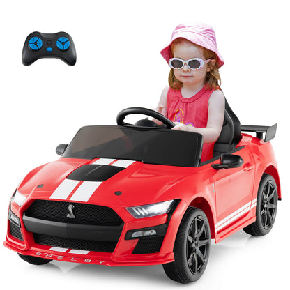 The kids electric car with a child sitting in the driver seat and a remote control above