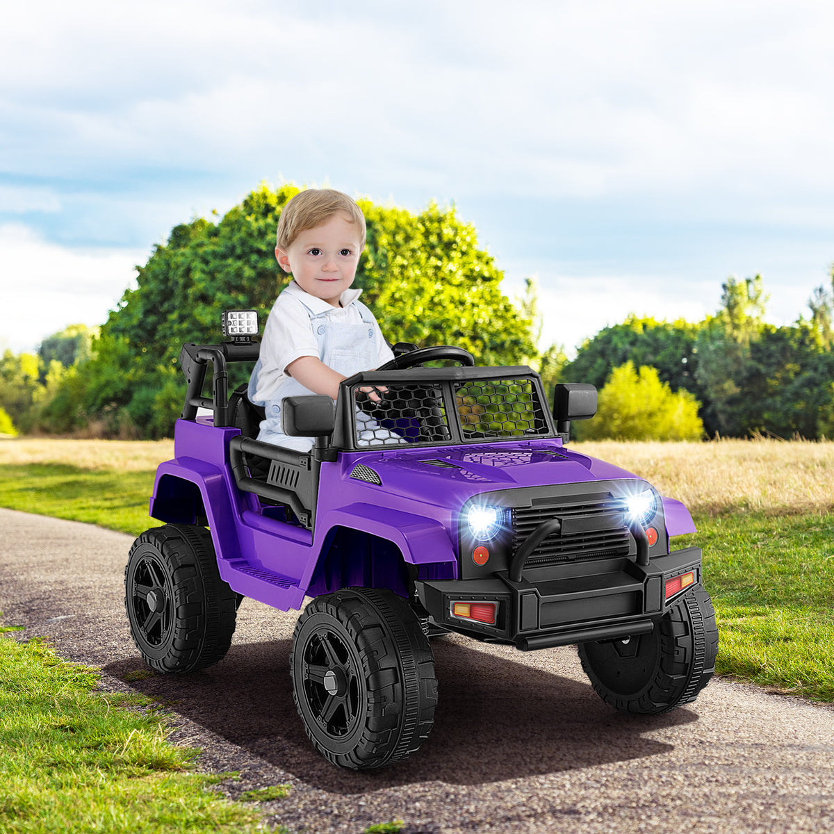 A toddler happily driving a purple kids electric car with remote control on a paved path outdoors