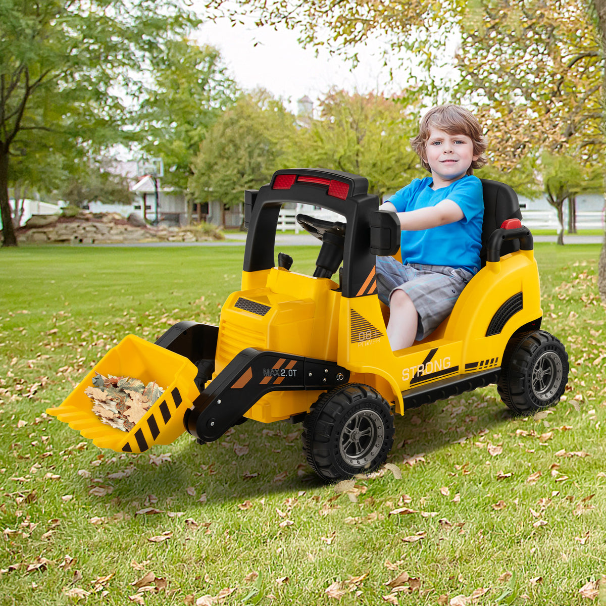 Young boy driving the yellow kids electric tractor in a garden
