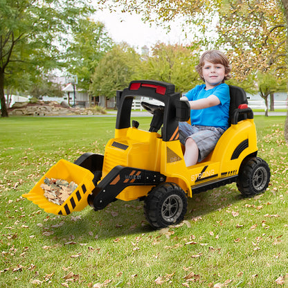 Young boy driving the yellow kids electric tractor in a garden