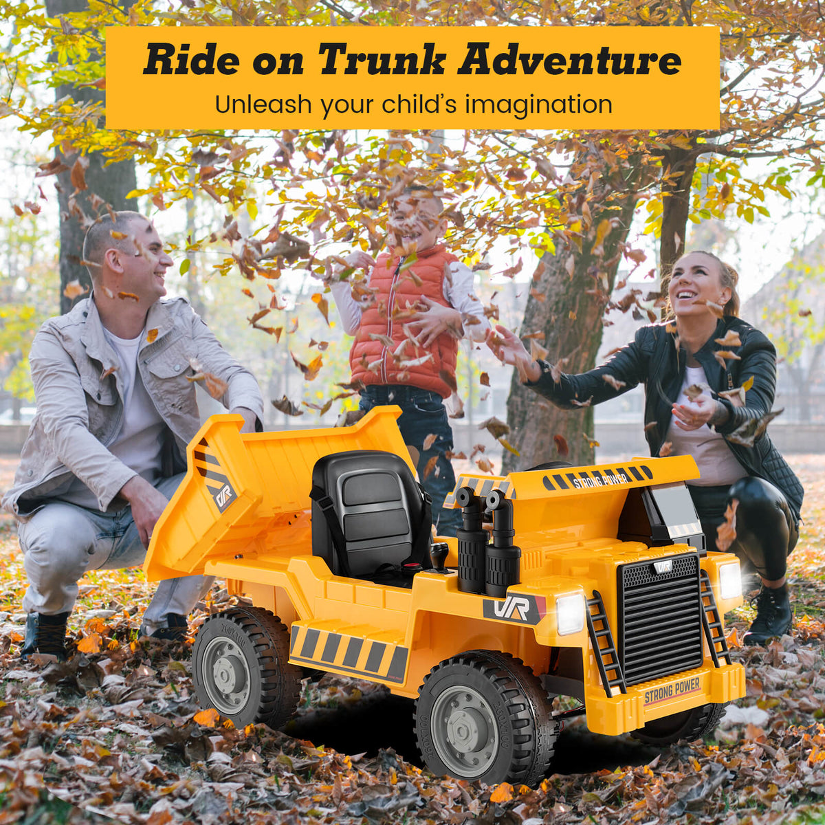 The yellow kids electric truck parked in a park with a family playing in the autumn leaves