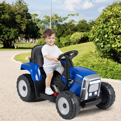 The blue kids electric tractor with trailer is shown from the side with a child at the wheel