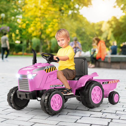 The pink kids electric tractor with a child sitting on the seat in a park