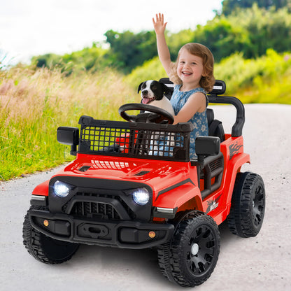 A red kids ride on truck car with a child and a dog in it, driving on a path