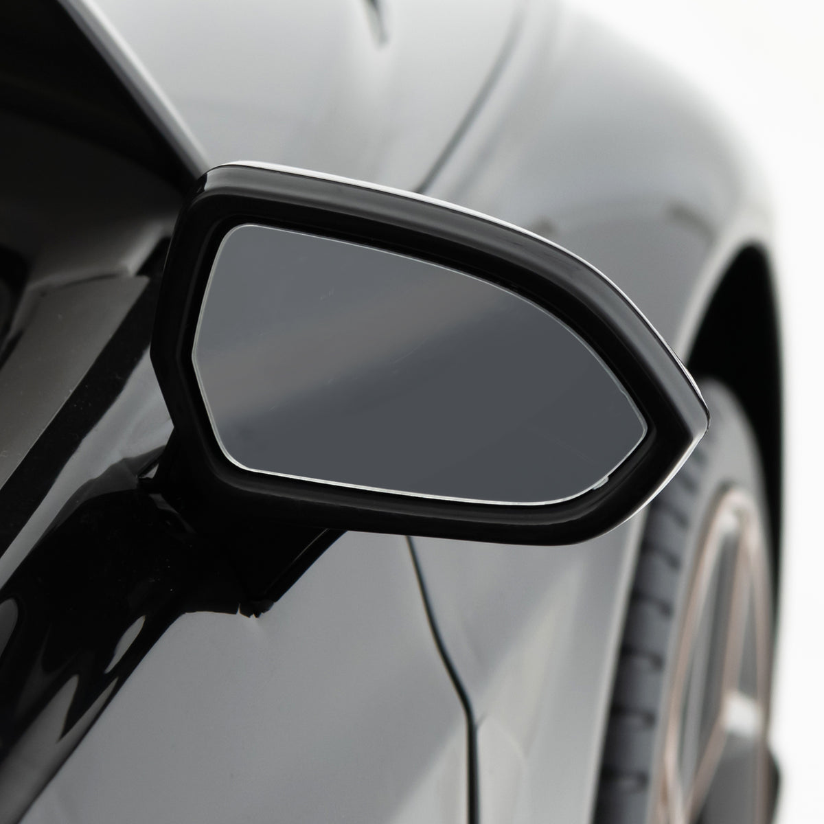 The side mirror of the black Bentley Bacalar kids electric car