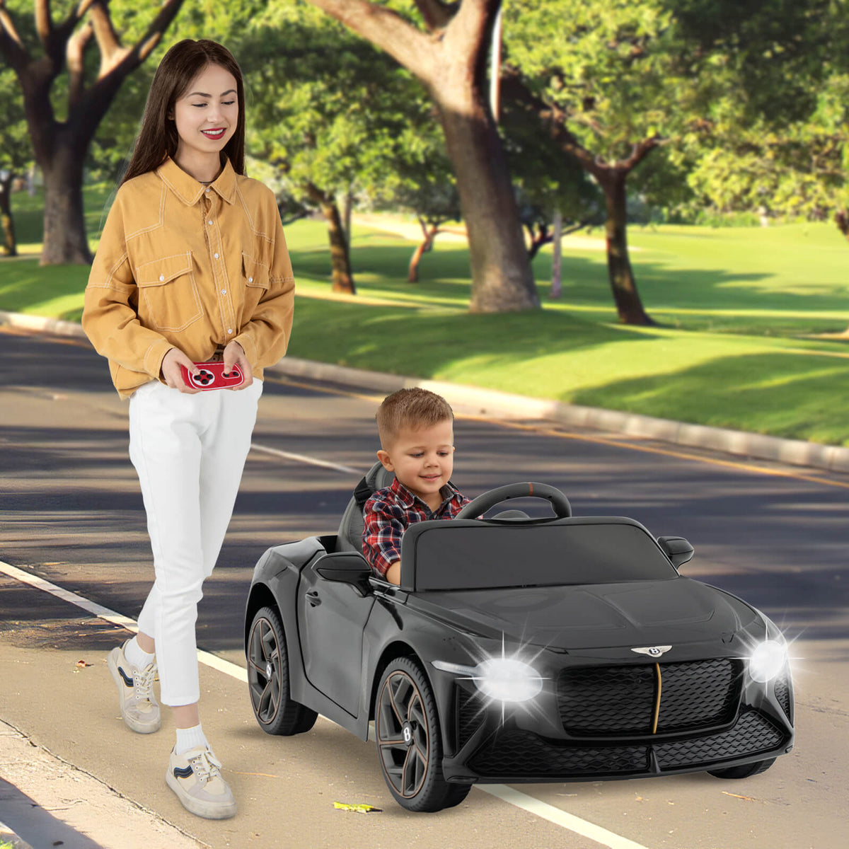 The black Bentley Bacalar kids electric car being operated on a paved path
