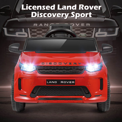 The red licensed Land Rover Discovery Sport electric car front view with headlights on