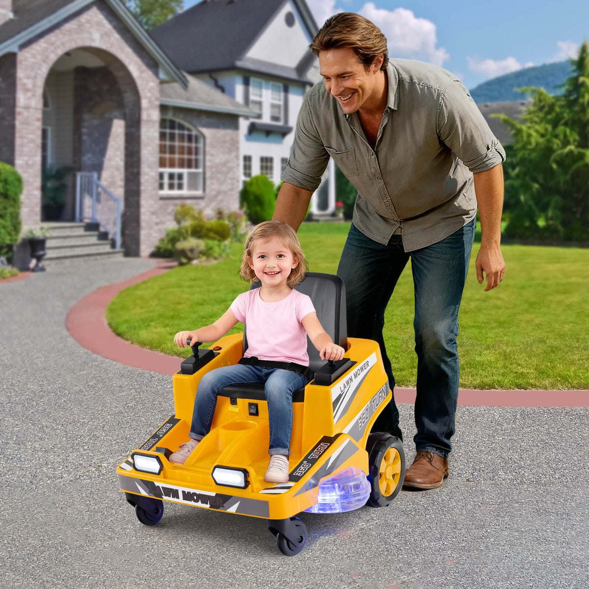 The yellow kids electric mower on a driveway with a smiling child sitting in the black seat
