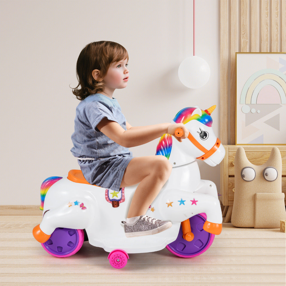 The kids electric car in a bright room with a child sitting on the orange seat