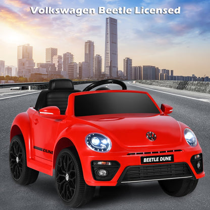 Red kids electric ride on car with a city skyline in the background