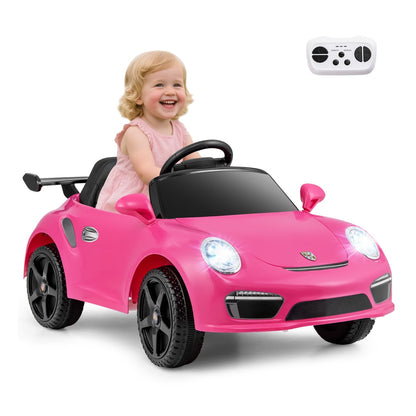 Rose pink electric car with a child driver and remote control in the air