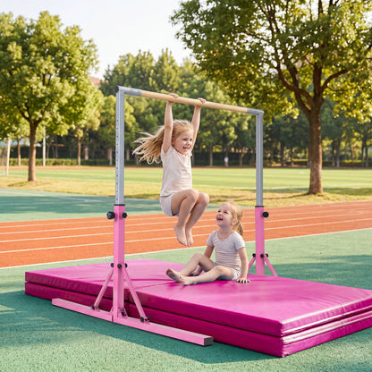 The pink foldable gymnastics bar with two children playing on mats outdoors