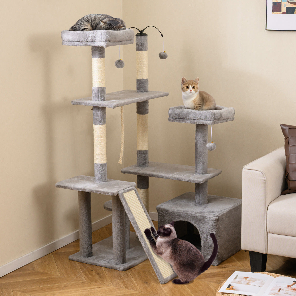 The cat tree placed in a living room next to a sofa with cats resting on the platforms