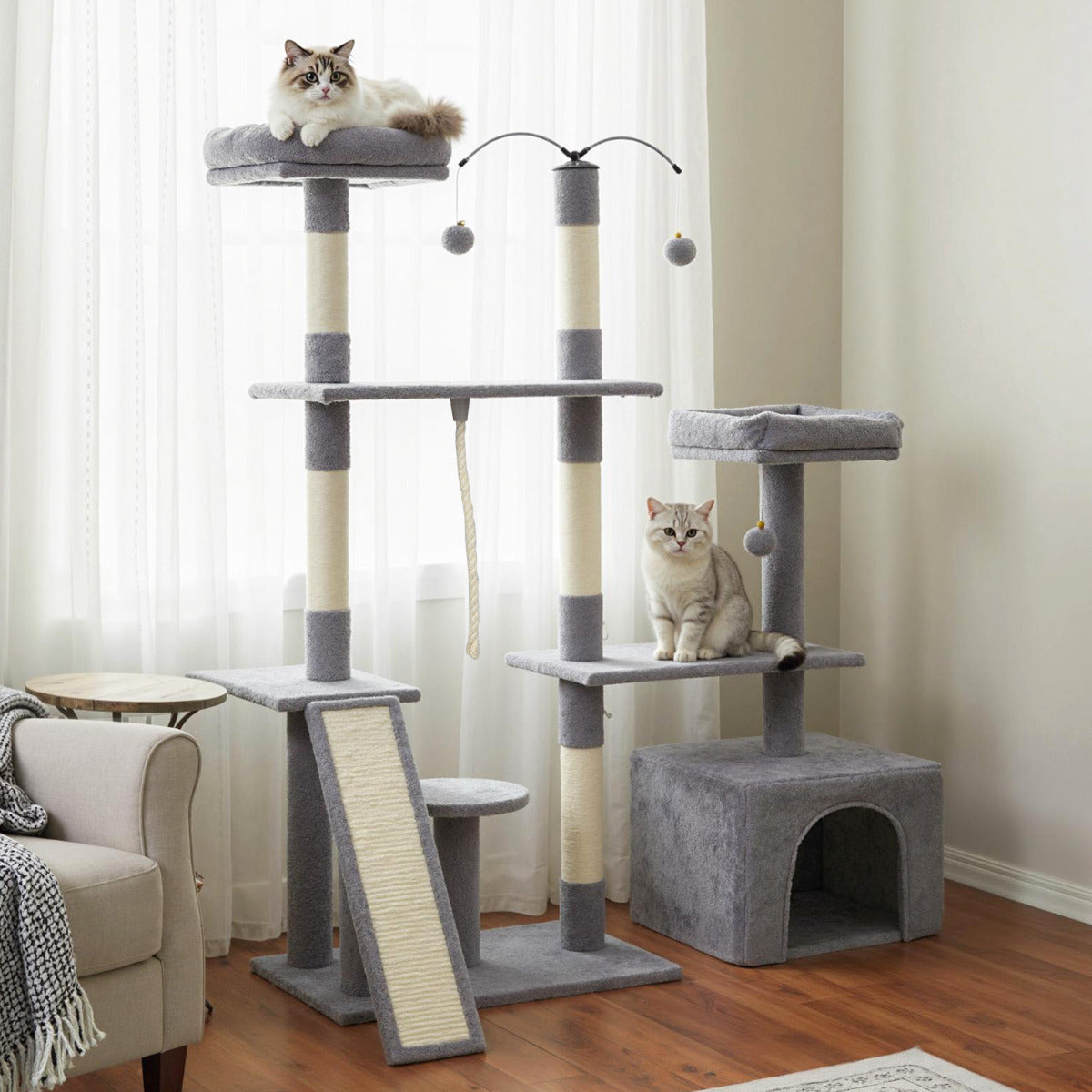 The cat tree standing in a bright room by a window with cats sitting on the levels
