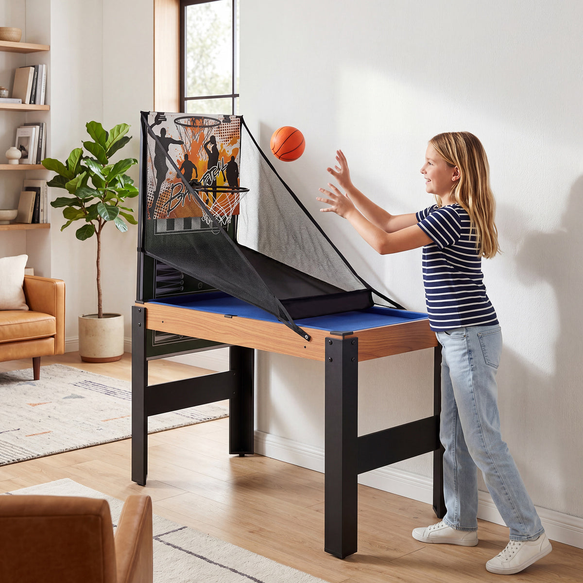 The multi-game table set up for basketball with a girl throwing a ball into the hoop