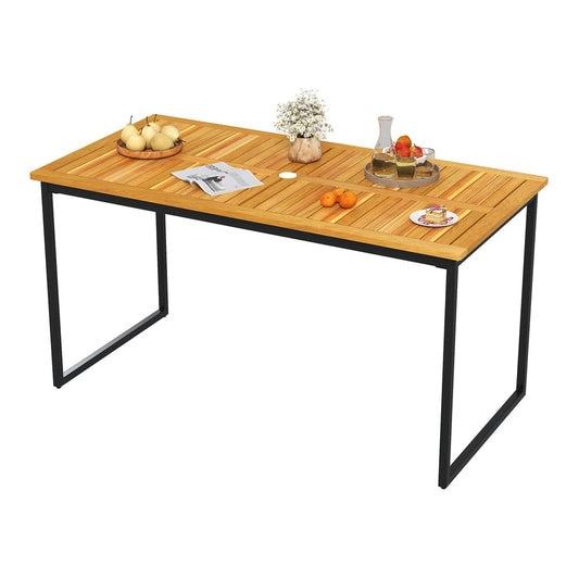 The acacia wood dining table set for a meal with fruit and drinks on its slatted surface