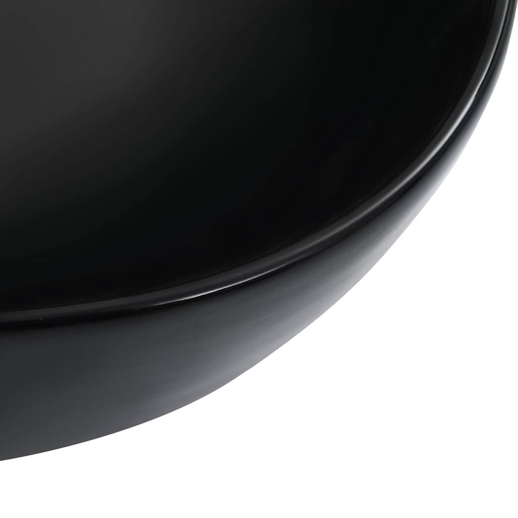 a close-up of the smooth, curved edge of the black ceramic basin