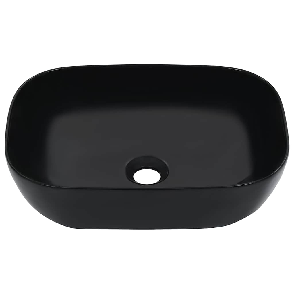 The black ceramic wash basin, a rectangular shape with rounded corners and a central drain hole