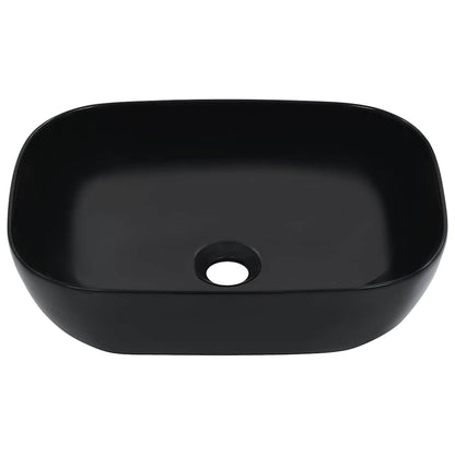 The black ceramic wash basin, a rectangular shape with rounded corners and a central drain hole