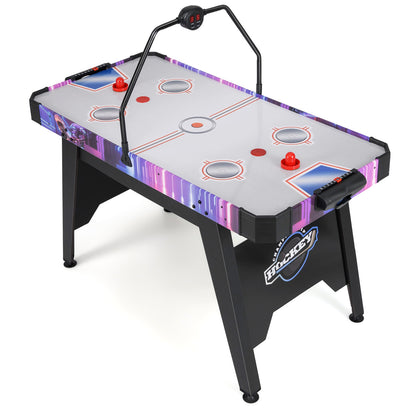 White and purple air hockey table with black legs, seen from a side angle