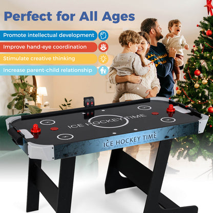 The air hockey table in a festive room with a Christmas tree