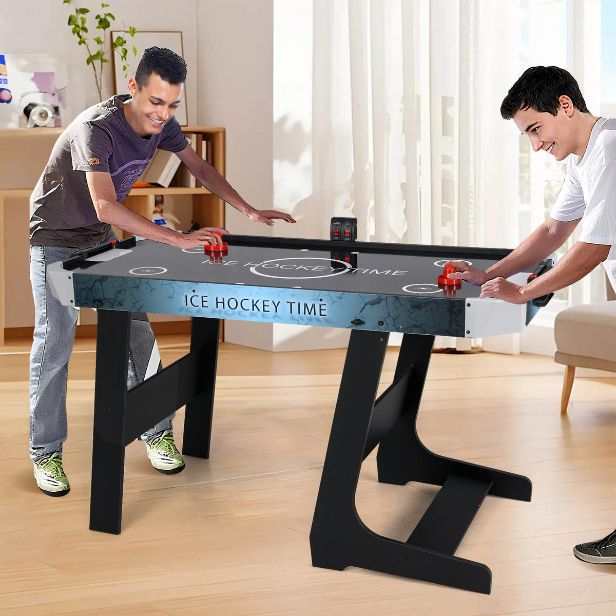 Two men playing the foldable air hockey table in a living room setting