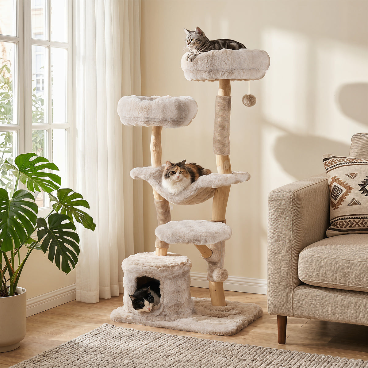 The cat tree tower in a living room with two cats playing on it