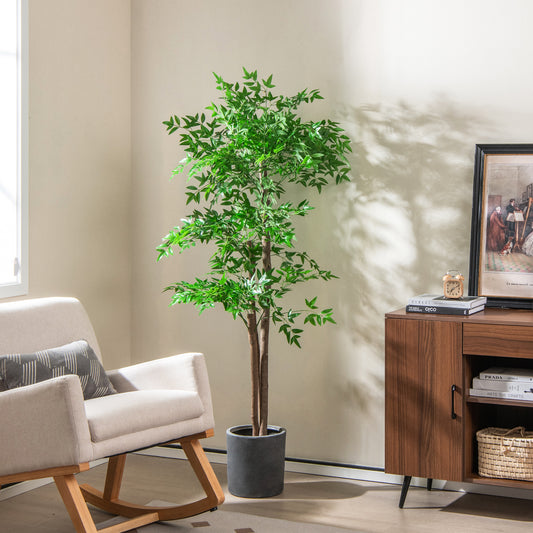 The faux bamboo plant placed in a modern living room next to a chair and cabinet