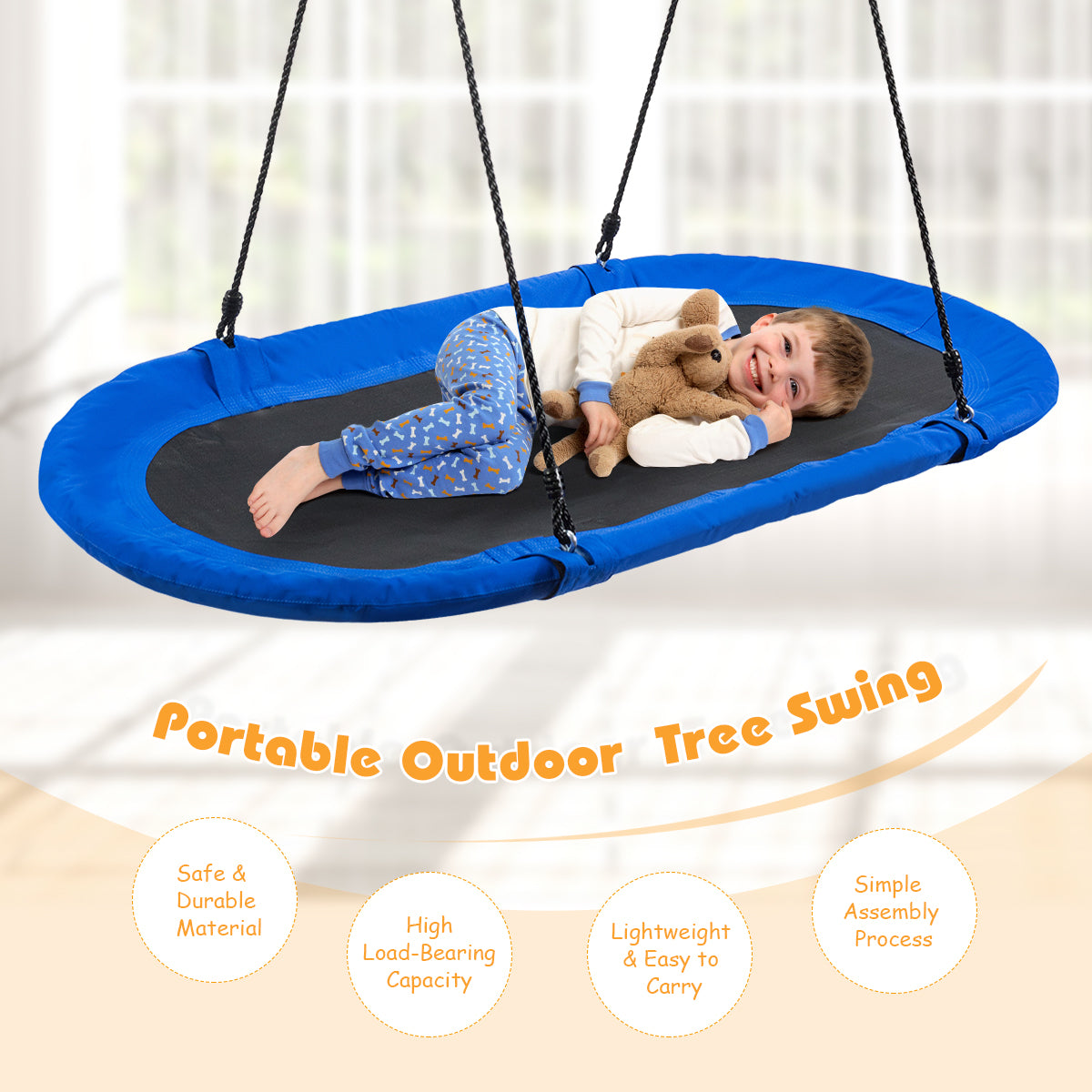 A young boy lying on the oval swing with a soft toy in a bright indoor room