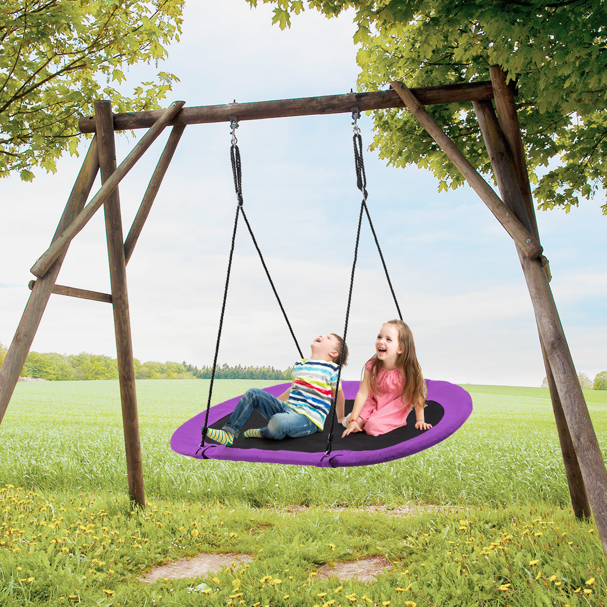 Two children enjoy the oval swing attached to a wooden frame outdoors
