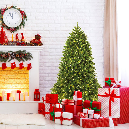 The Christmas tree is set up in a living room next to a fireplace decorated for Christmas