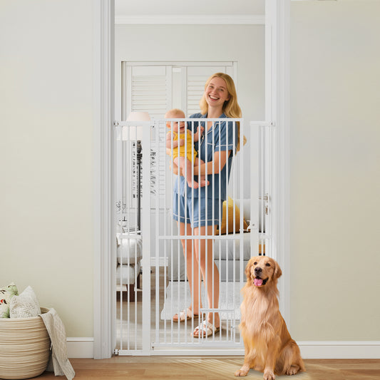 The tall pet gate is open, with a woman holding a baby and a golden retriever sitting in a doorway