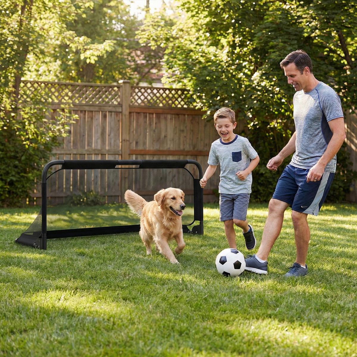 A father and son play soccer with their dog in a garden with the goal set up