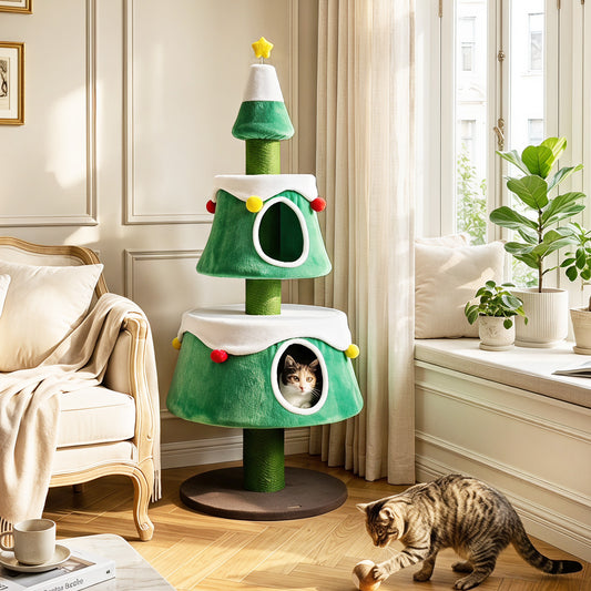 A green cat Christmas tree with two condos and scratching posts in a living room with a cat playing
