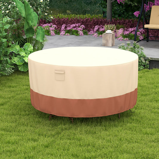 The patio furniture cover protecting a round table and chairs set on a green lawn