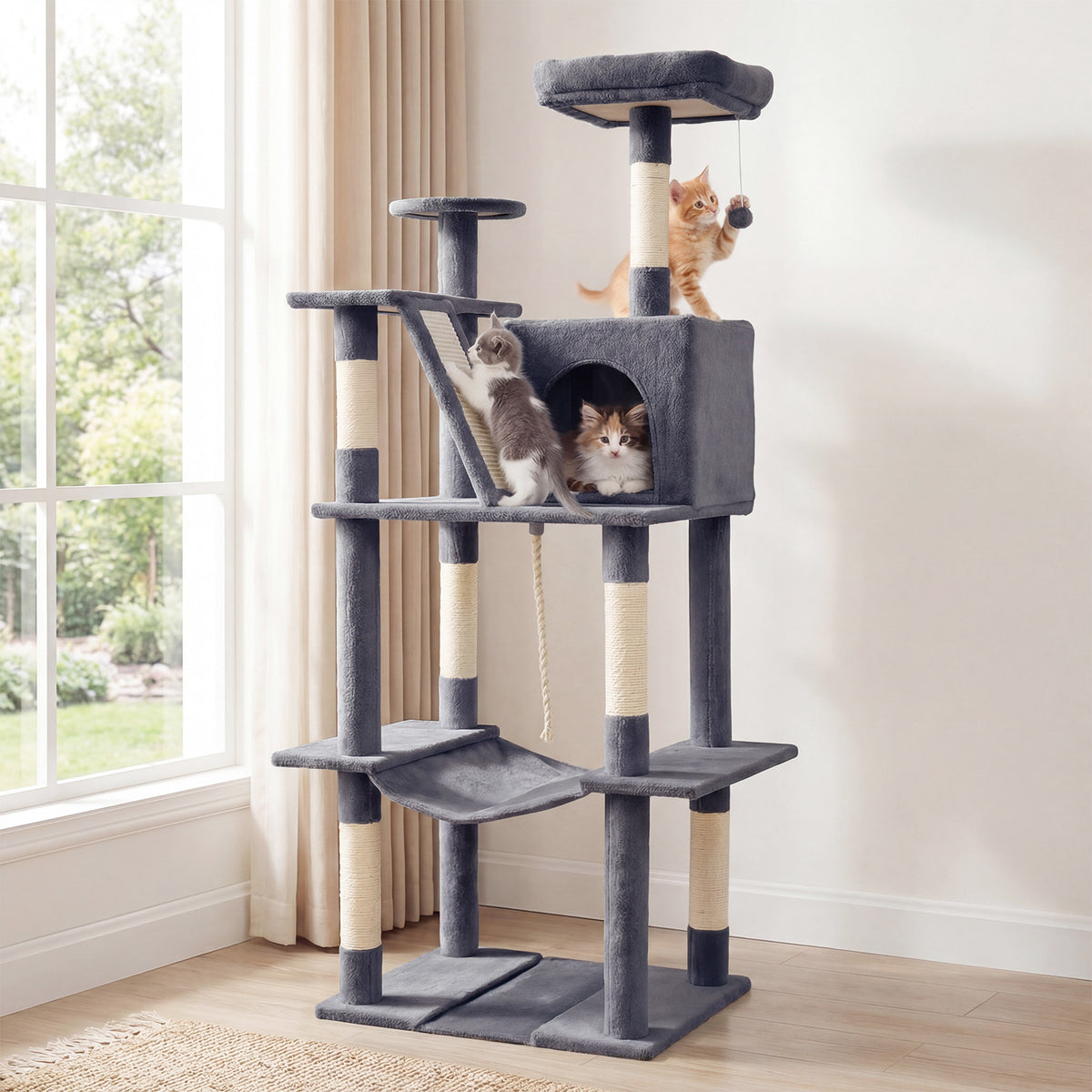 The cat tree tower in a living room with two kittens playing on it