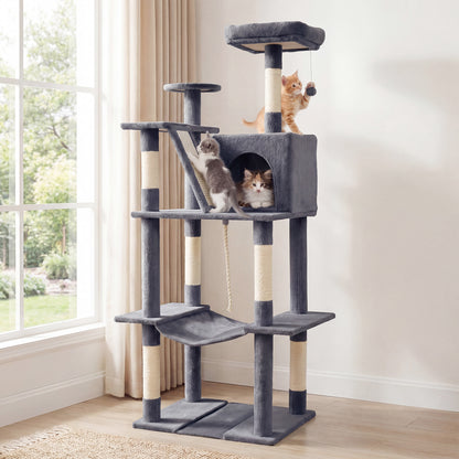 The cat tree tower in a living room with two kittens playing on it