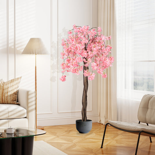 The artificial cherry blossom tree with pink flowers in a grey pot in a living room