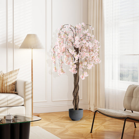 The artificial cherry blossom tree in a grey pot standing on a wooden floor