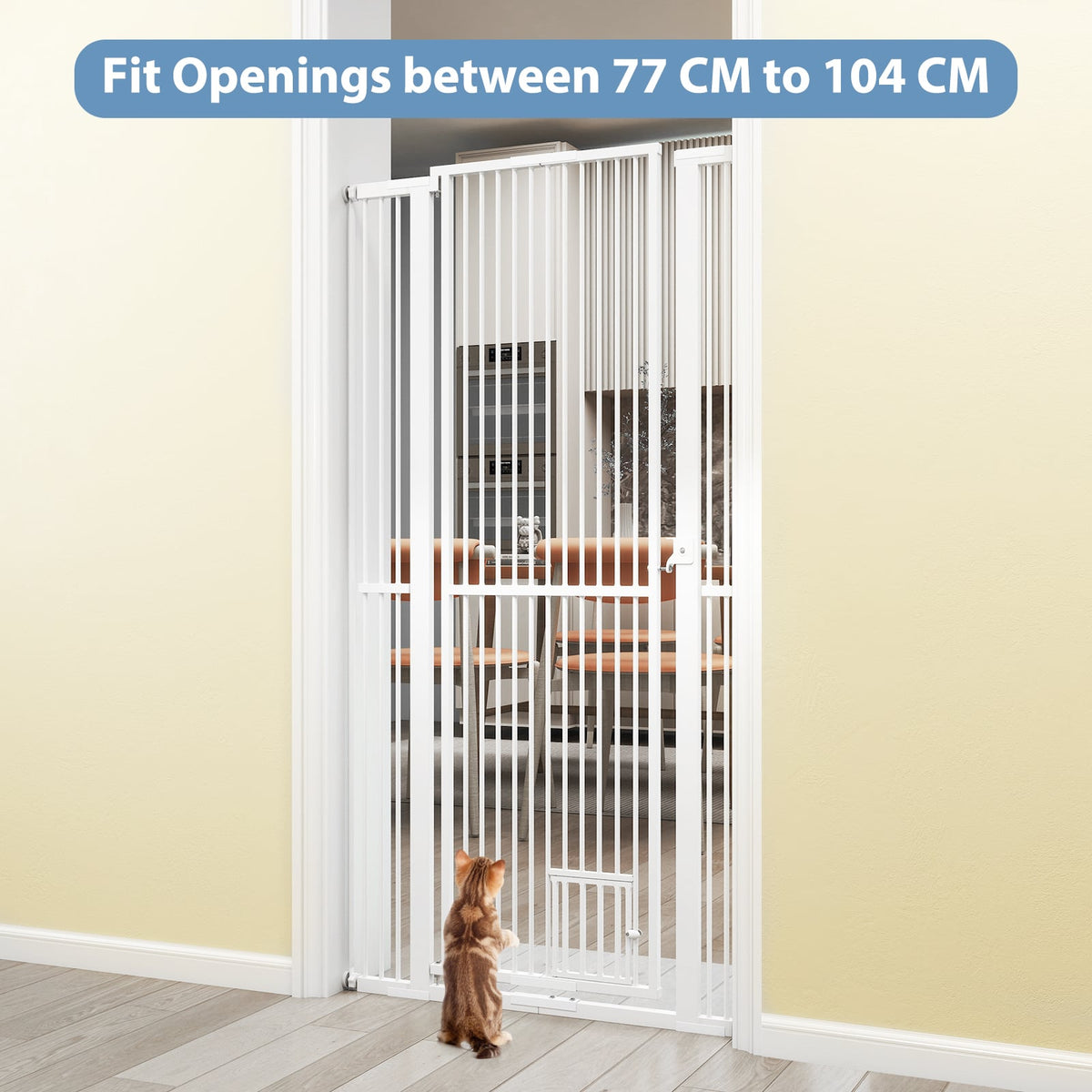 A small cat stands in front of the tall white metal pet gate, which is installed in a doorway