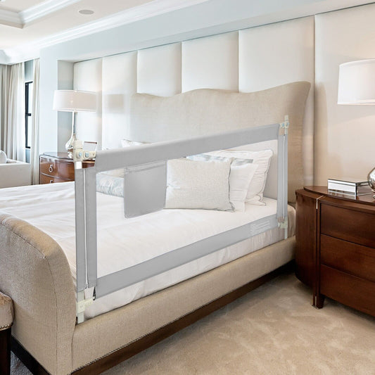 the grey safety barrier mounted on a bed with a soft padded top rail and storage pocket