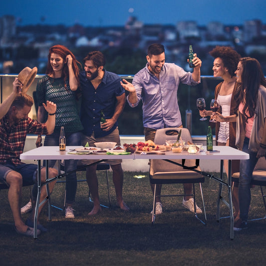 The folding plastic dining table set up for a party on a rooftop terrace