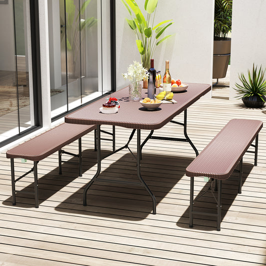 The patio table set up for an outdoor meal with two benches