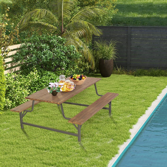 The patio picnic table bench set is set up on a lawn next to a swimming pool