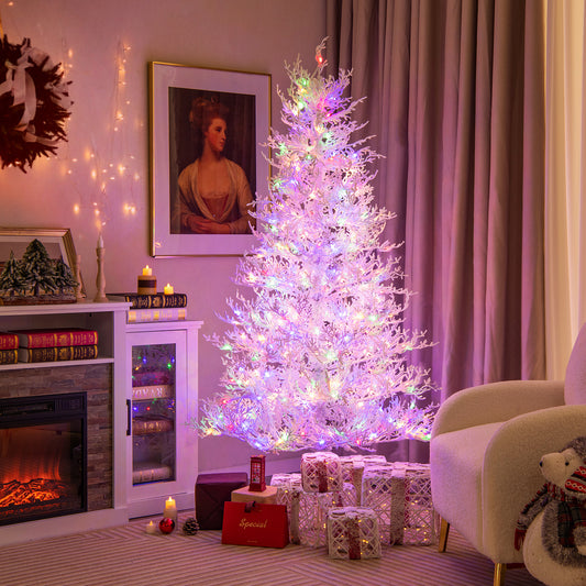 The white hinged Christmas tree decorated with colourful lights in a cosy room setting