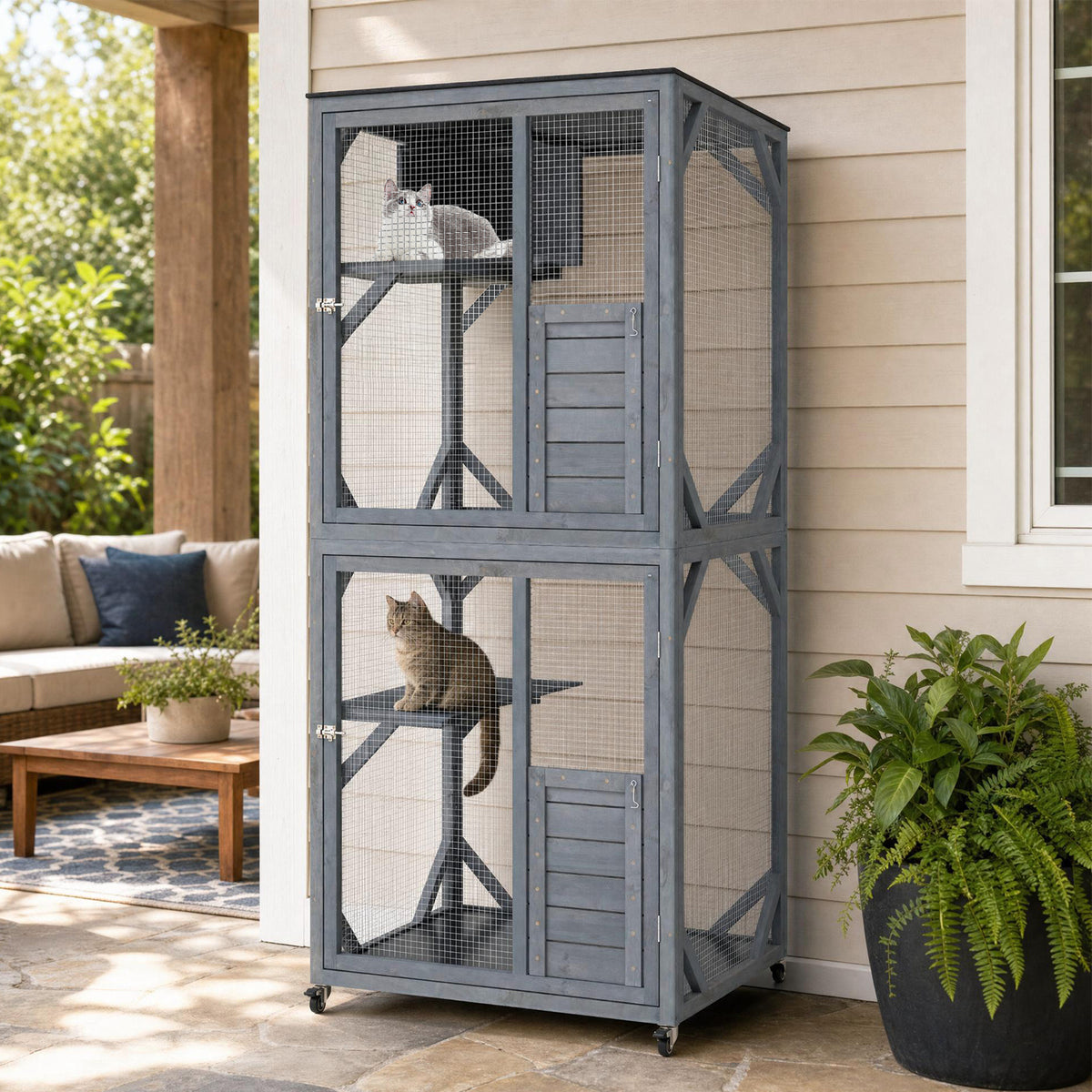 The cat furniture standing on a patio with two cats resting inside the enclosure