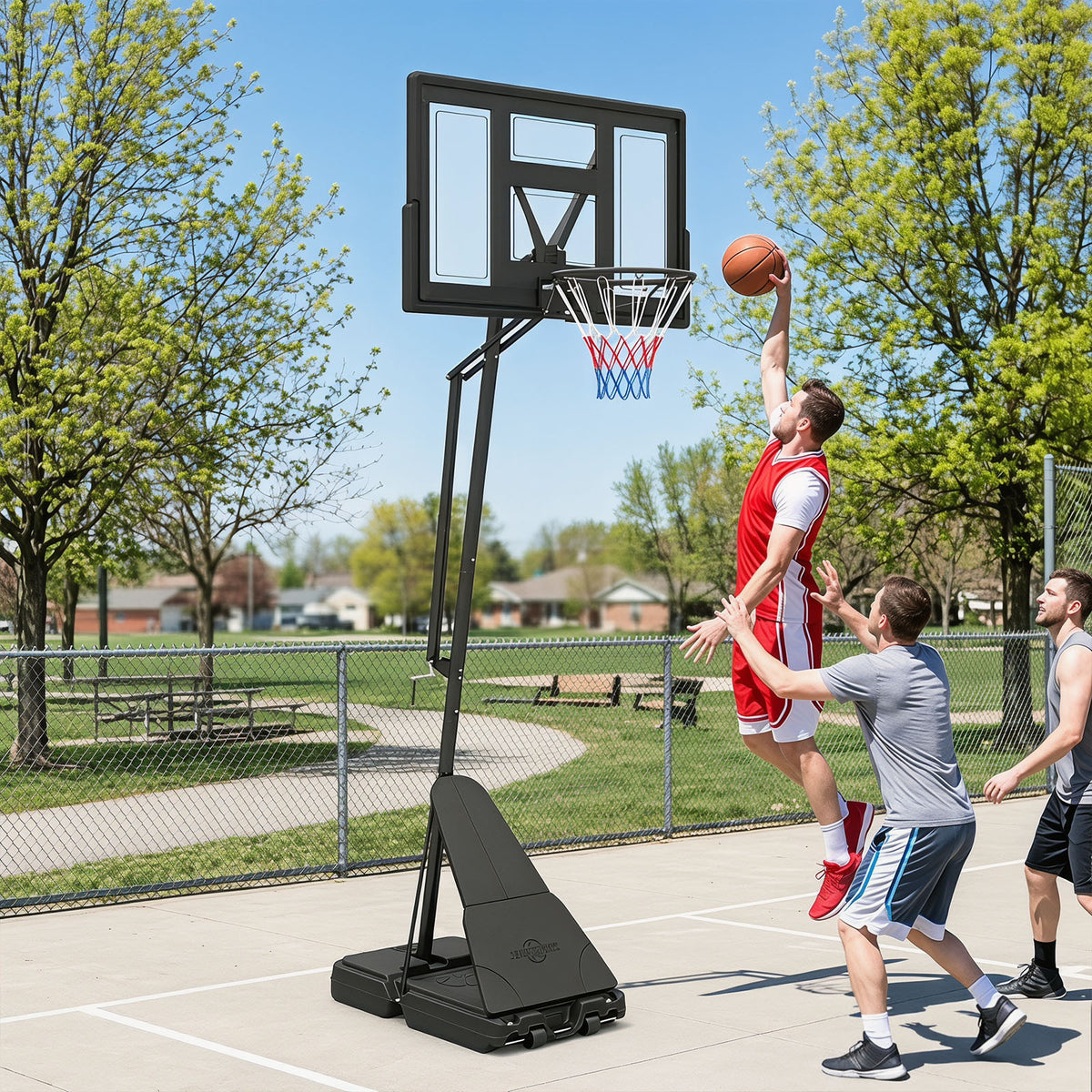 Men playing basketball on an outdoor court with the hoop