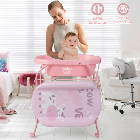 The changing station in use with a mother bathing her baby in the pink tub