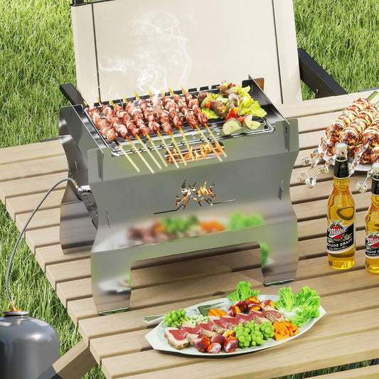 The outdoor grill placed on a wooden table with skewers cooking over the flame